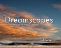 Blue and orange sky over gentle waves crashing on beach, on cover of 'Dreamscapes, Finding a Place to Call to Call Your Own', by ACC Art Books.
