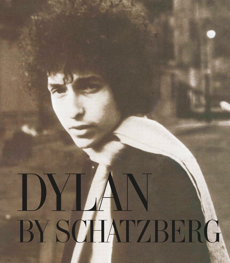 Bob Dylan in a white scarf looking at camera, on cover of 'Dylan By Schatzberg', by ACC Art Books.