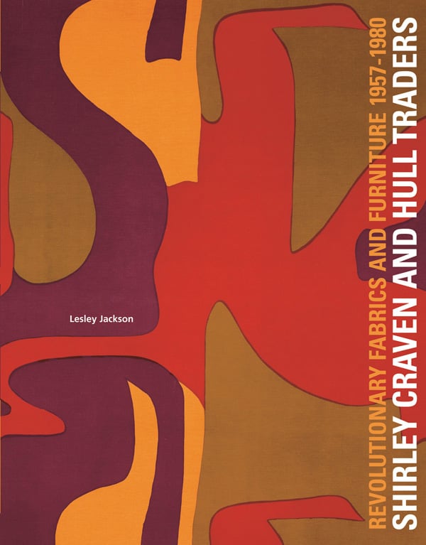 Bold 60s abstract fabric design in aubergine, orange and green, on cover of 'Shirley Craven and Hull Traders, Revolutionary Fabrics and Furniture 1957-1980', by ACC Art Books.