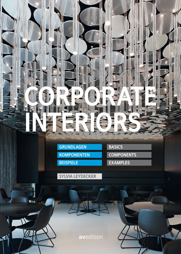 Interior space: round tables with chairs, low hanging clear lights, on cover of 'Corporate Interiors, Basics, Components, Examples', by Avedition Gmbh.