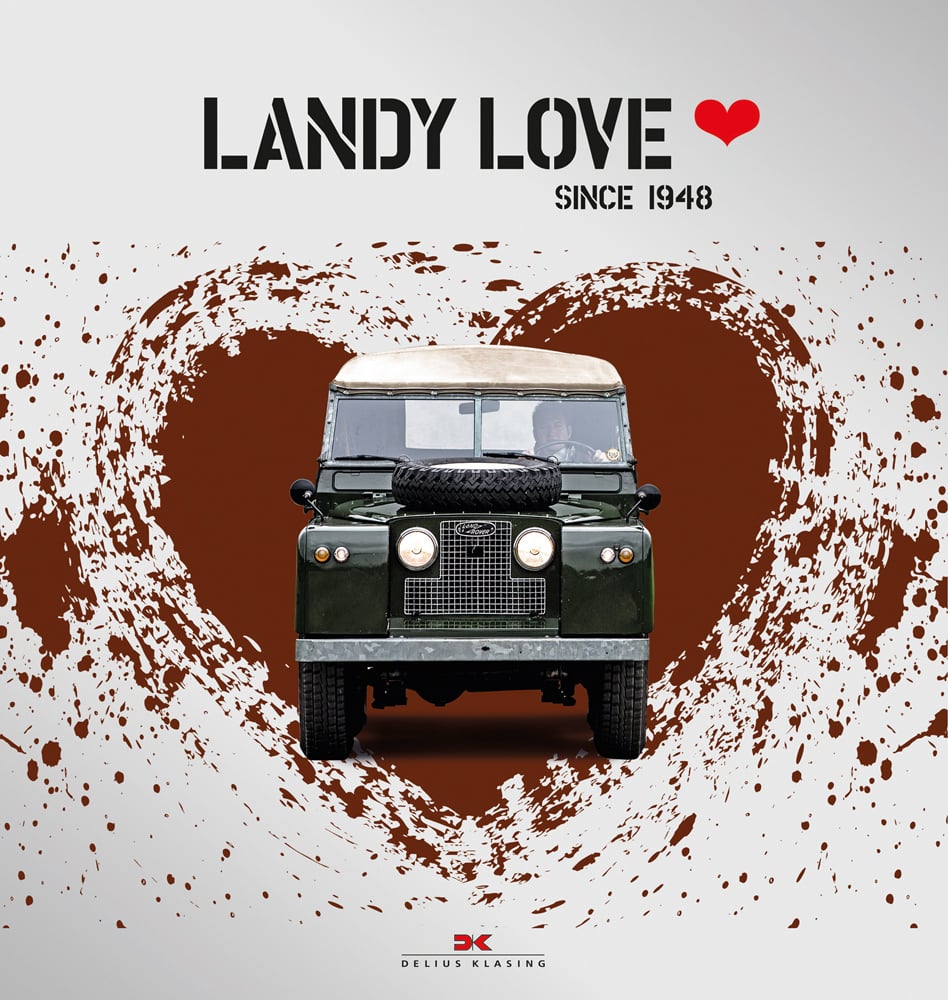 Front of Land Rover with driver, to centre of red heart, on white cover of 'Landy Love, Since 1948', by Delius Klasing.