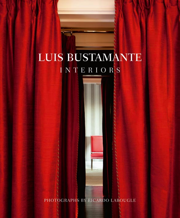 Three sets of long red curtains leading to a red chair, on cover of 'Luis Bustamante: Interiors', by Ediciones El Viso.