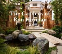 Book cover of The Gardens of Ron Herman, with a modern garden with small pond and large rocks, trellis with green foliage, house with brick columns behind. Published by Grayson Publishing.