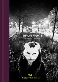 Book cover of Christian Reister’s Berlin Nights, with figure wearing a white cat mask, city lights behind. Published by Hoxton Mini Press.