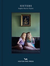 Book cover of Sophie Harris-Taylor's Sisters, with two females sitting on sofa with foreheads touching. Published by Hoxton Mini Press.