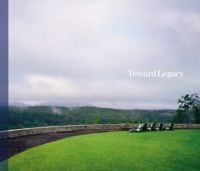 Book cover of Toward Legacy, with a low brick wall boundary line with hills behind. Published by Spacemaker Press.