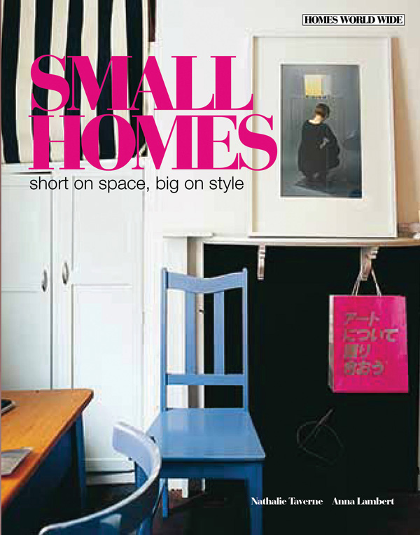 Interior with blue wooden chair, white cupboards, desk and a framed art print on the wall, on cover of 'Small Homes short on space, big on style', by Lannoo Publishers.