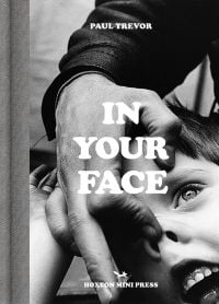 Book cover of Paul Trevor's In Your Face, with portrait of boy having nose pushed up like a pig by another hand. Published by Hoxton Mini Press.