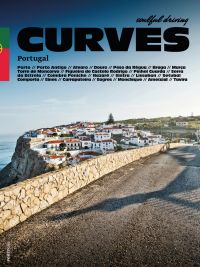 Road traveling towards homes by the sea, on cover of 'Curves: Portugal, Band 14', by Delius Klasing.