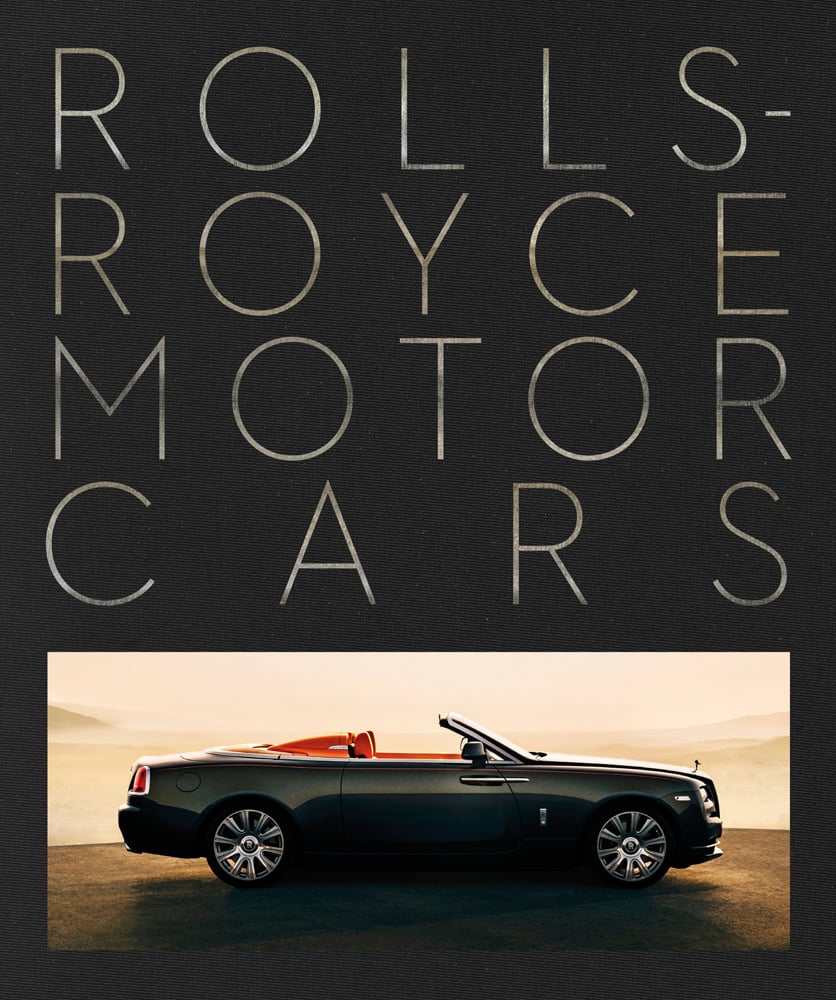Black Rolls Royce Dawn with aero cowling, on black cover of 'Rolls-Royce Motor Cars, Making a Legend', by ACC Art Books.