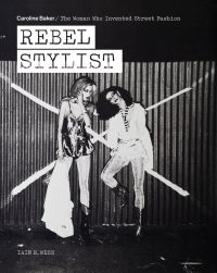Two fashion models posing in front of corrugated fence with large white X, on cover of 'Rebel Stylist', by ACC Art Books.