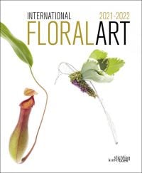 White book cover of International Floral Art 2021/2022, with carnivorous monkey cup plant and foliage made into hummingbird. Published by Stichting.