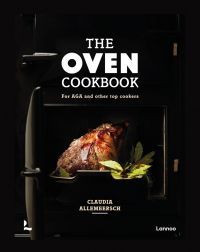 Joint of meat with bay leaves cooking in roasting tin, in black AGA, on cover of 'The Oven Cookbook, For AGA and Other Top Cookers', by Lannoo Publishers.