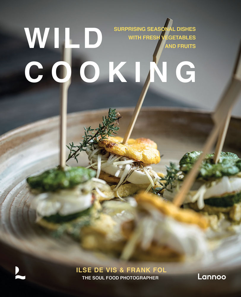 Plate of small green and yellow stacked canapes, on cover of 'Wild Cooking, Surprising Seasonal Dishes With Fresh Vegetables and Fruits', by Lannoo Publishers.