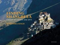 Breath taking photograph of white building complex up a mountainous landscape, Finding Shangri-La in orange font