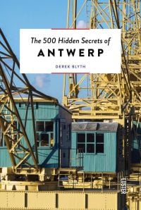 Large yellow steel structure towering over green wooden outhouses, on cover of 'The 500 Hidden Secrets of Antwerp', by Luster Publishing.