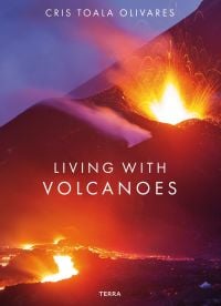 Spectacular shot of volcano spewing bright white and orange lava, on cover of 'Living With Volcanoes', by Lannoo Publishers.