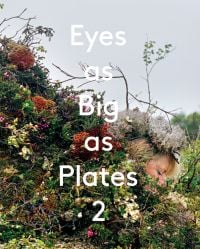 White female head adorned with fine foliage surrounded by green moss, flowers and leaves, on cover of 'Eyes as Big as Plates 2', by Arnoldsche Art Publishers.