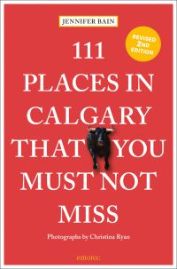 Black bull near center of red cover of '111 Places in Calgary That You Must Not Miss', by Emons Verlag.
