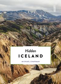 Aerial view of gold, blue and green mountainous landscape, on cover of 'Hidden Iceland', by Luster Publishing.