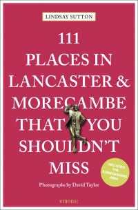 Bronze statue of Eric Morecambe near centre of red cover of '111 Places in Lancaster and Morecambe That You Shouldn't Miss', by Emons Verlag.
