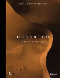 Aerial view of desert landscape with sand dunes, on cover of 'Deserted', by Lannoo Publishers.