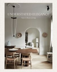 Interior dining space with wood table and chairs, high ceiling, low light fitting, on cover of 'Understated Elegance, New Urban Living', by Beta-Plus.