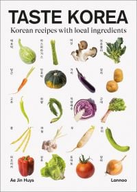 White cover of Taste Korea: Korean Recipes With Local Ingredients, with Korean vegetables: red pepper, white dadagi cucumber. Published by Lannoo Publishers.