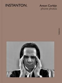 Australian singer songwriter Nick Cave, with eyes closed and fingers at temples, on cover of 'Instanton, Phone Photos', by Hannibal Books.