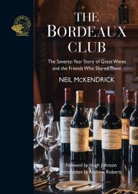 Bottles of vintage red wine on table, with wine glasses, on cover of 'The Bordeaux Club, The convivial adventures of 12 friends and the world's finest wine', by Academie du Vin Library.