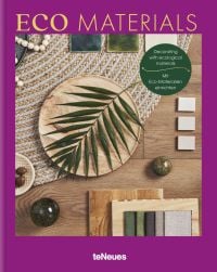 Aerial view of wood floor with woven rug, wooden plate with green palm leaf, on purple cover of 'Eco Materials, Decorating with Ecological Materials', by teNeues Books.