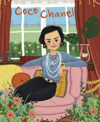 Book cover of Coco Chanel, Genius, with the French fashion designer wearing pearl necklaces, sitting on pink sofa. Published by White Star.