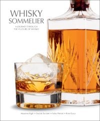 Book cover of Whisky Sommelier, A Journey Through the Culture of Whisky', with a glass of whisky with an ice cube, and crystal decanter. Published by White Star.