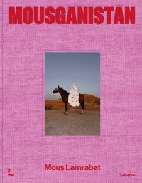 Pink linen book cover of Mous Lamrabat’s Mousganistan, with a figure in white robe sitting on horse surrounded by desert. Published by Lannoo Publishers.