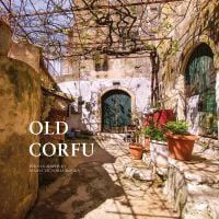 Book cover of Old Corfu, with a sunny village walkway leading to dark double doors of building, potted plants to right. Published by ACC Art Books.