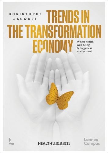 Book cover of Christophe Jauquet's Trends in the Transformation Economy: Where Health, Well-Being & Happiness Matter Most, with a pair of hands folding a gold butterfly. Published by Lannoo Publishers.