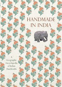 Book cover of Handmade in India: A Geographic Encyclopedia of Indian Handicrafts, with a ceramic elephant, and floral print. Published by Abbeville Press.