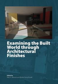 Book cover of Examining the Built World through Architectural Finishes, with a large interior room with desk and screens. Published by Archetype Publications.