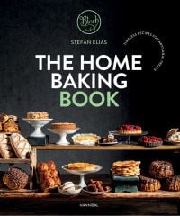 Book cover of The Home Baking Book: Timeless Recipes for Artisanal Treats, with a table of bread, pastries, cakes and tarts. Published by Hannibal Publishers.