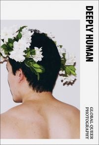 Book cover of Deeply Human: Global Queer Photography, with the back a male wearing a white flower headpiece. Published Verlag Kettler.