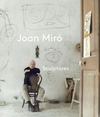 Book cover of Joan Miró: Sculptures, with the artist sitting on a chair in his studio. Published by Waanders Publishers.