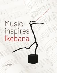 Book cover of Music Inspires Ikebana, with a tree branch shape with a conductors baton fixed to one end. Published by Stichting Kunstboek.