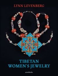 Book cover of Lynn Levenberg's Tibetan Women’s Jewelry, with a Tibetan Ga’u Box set with Turquoise and glass Dzi Beads. Published by Arnoldsche Art Publishers.