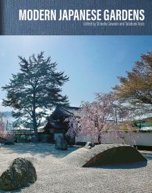 Book cover of Modern Japanese Gardens, with a Japanese garden with stones, pink blossom tree and small bridge. Published by ACC Art Books.