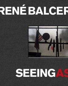 Book cover of Seeing As, René Balcer, with a row of knives and a machete on magnetic strip, with American flag and globe to left. Published by ACC Art Books.