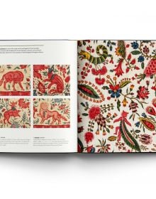 Fabric print with gold shapes and lines, red bugs, and blue grass, on cover of 'Book of Textiles, An inspiring journey through the enigmatic world of pattern and cloth', by ACC Art Books.