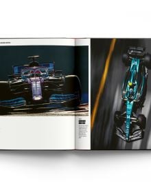 Book cover of Grands Prix: 75 Years of Formula One Racing, with Lewis Hamilton racing his Mercedes F1 car. Published by ACC Art Books.