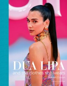 Book cover of Scarlett Conlon's Dua Lipa: And the Clothes She Wears, with the disco star posing in a floral Bottega Veneta dress at the Barbie premiere. Published by ACC Art Books.