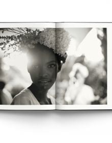 Book cover of La Dolce Vita: Inside the World of Dolce&Gabbana’s Alta Moda Fashion Shows, featuring a model in a large floral dress standing amongst a rocky mountain. Published by ACC Art Books.