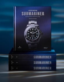 Book cover of Oyster Perpetual Submariner: The Watch that Unlocked the Deep, with a silver, black-faced Rolex watch. Published by Wallpaper*.